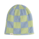 Checkered beanie with green and blue squares on a white background