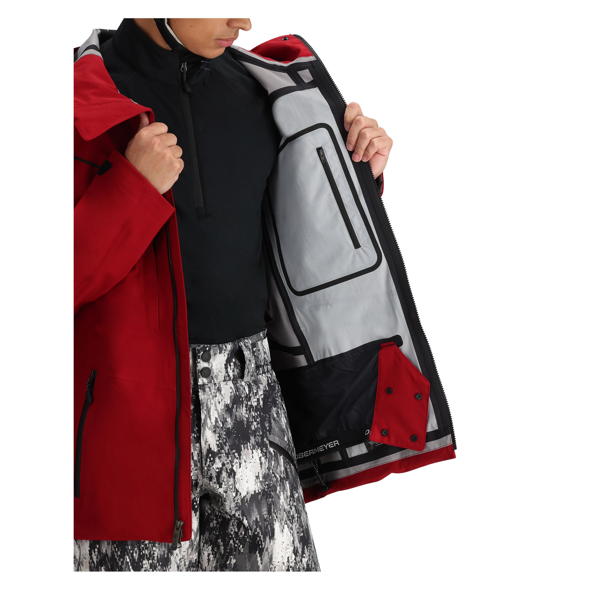 Obermeyer Foraker Shell Jacket 2025 - A red, black, and gray jacket with a zippered chest pocket on the right side.