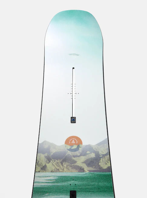Burton Women's Family Tree Story Board B Grade Snowboard 2024 - A snowboard with a light blue-green top and a mountain range design at the bottom.