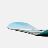 Burton Women's Family Tree Story Board B Grade Snowboard 2024 - A snowboard with a light blue top sheet and dark gray base, featuring a distinctive Burton logo on the bottom of the board.