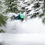 Anon Merak Wavecel Helmet 2025 - A black helmet with a white logo on the front, featuring a wave pattern and a strap under the chin.