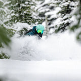 Anon Merak Wavecel Helmet 2025 - A black helmet with a white logo on the front, featuring a wave pattern and a strap under the chin.