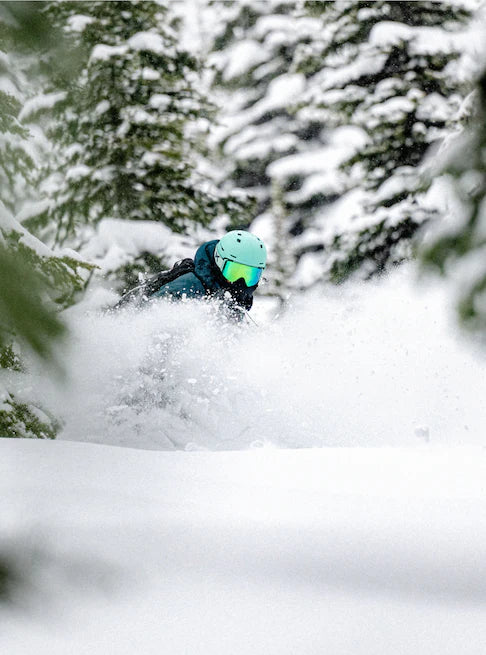 Anon Merak Wavecel Helmet 2025 - A black helmet with a white logo on the front, featuring a wave pattern and a strap under the chin.
