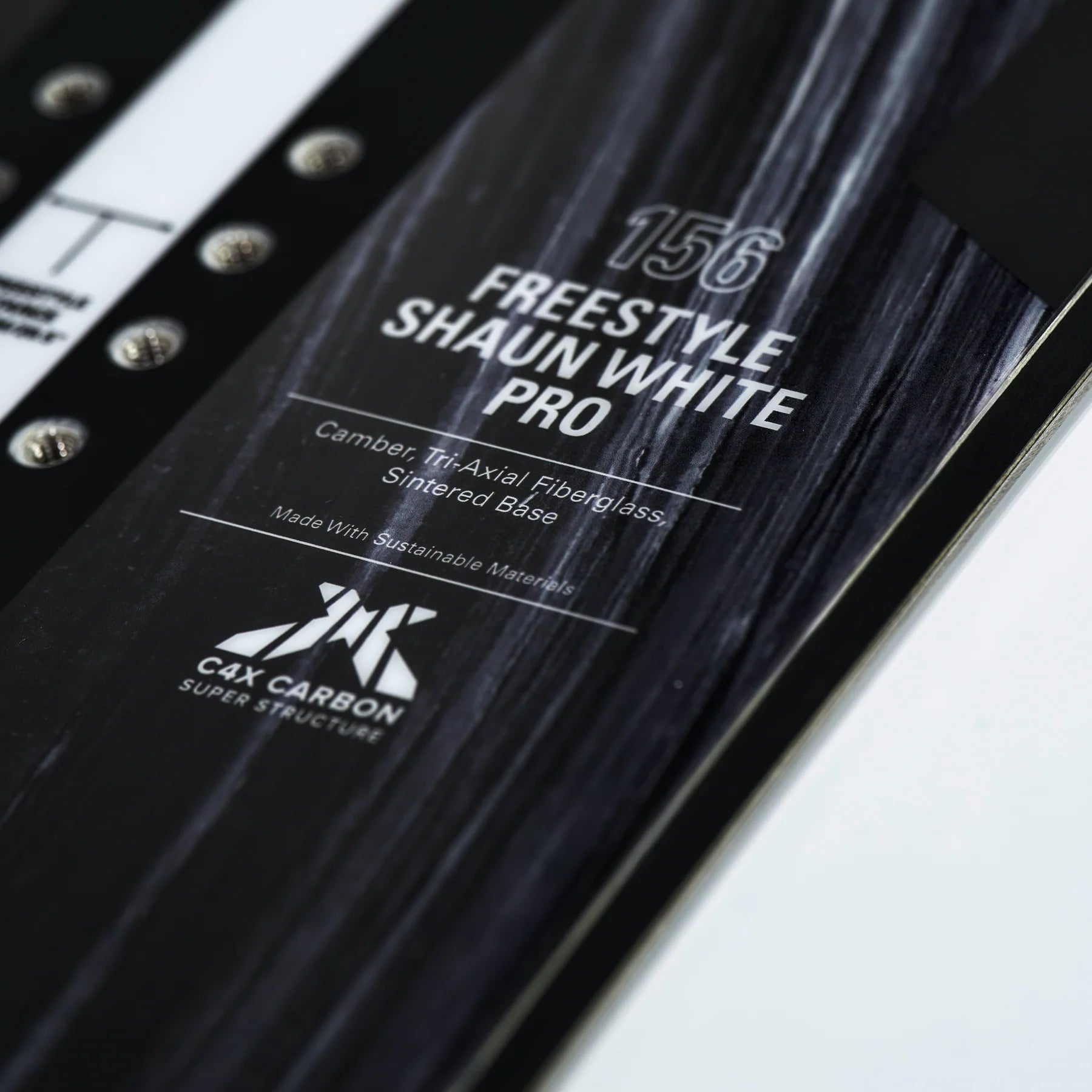 Whitespace Freestyle Shaun White Pro Snowboard 2024 - A black snowboard with white lettering and a white logo on top.