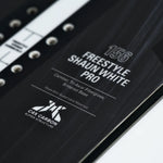 Whitespace Freestyle Shaun White Pro Limited Edition Snowboard 2024 - A black snowboard with white lettering and a distinctive "Whitespace" logo on top.