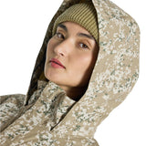 Burton Women's Frosnter Anorak Jacket 2025 - A tan jacket with a white and green camouflage pattern, featuring a hood and a zipper down the front.