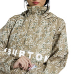 Burton Women's Frosnter Anorak Jacket 2025 - A tan jacket with a white and green snowflake pattern, worn by a woman in a beige knit hat.