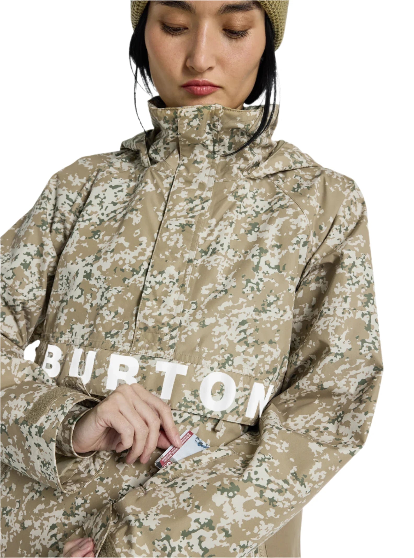 Burton Women's Frosnter Anorak Jacket 2025 - A tan jacket with a white and green snowflake pattern, worn by a woman in a beige knit hat.