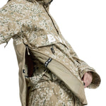 Burton Women's Frosnter Anorak Jacket 2025 - A tan jacket with a white and green snowflake pattern, featuring a zippered chest pocket and adjustable cuffs.