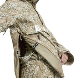 Burton Women's Frosnter Anorak Jacket 2025 - A tan jacket with a white and green snowflake pattern, featuring a zippered chest pocket and adjustable cuffs.