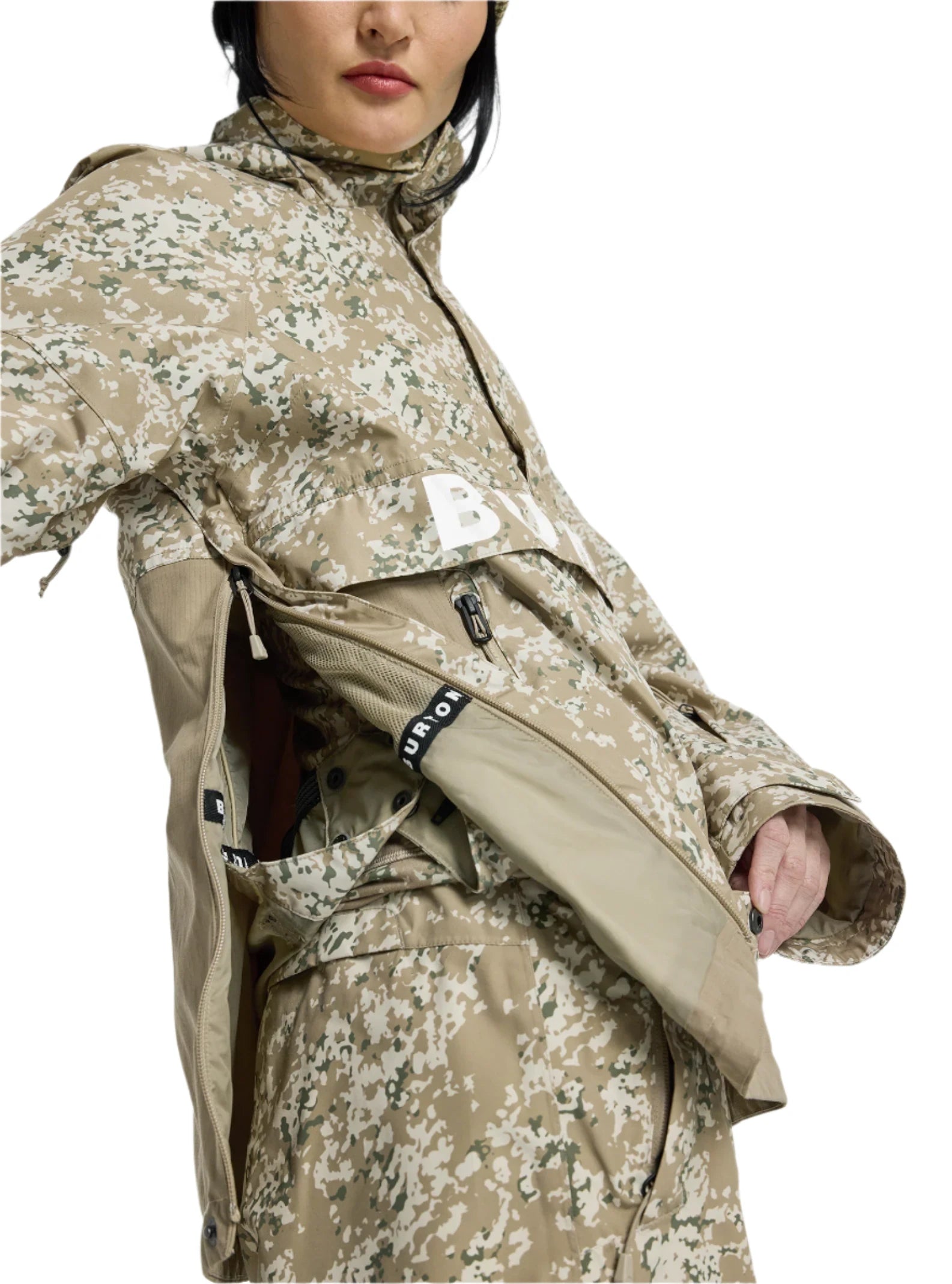 Burton Women's Frosnter Anorak Jacket 2025 - A tan jacket with a white and green snowflake pattern, featuring a zippered chest pocket and adjustable cuffs.