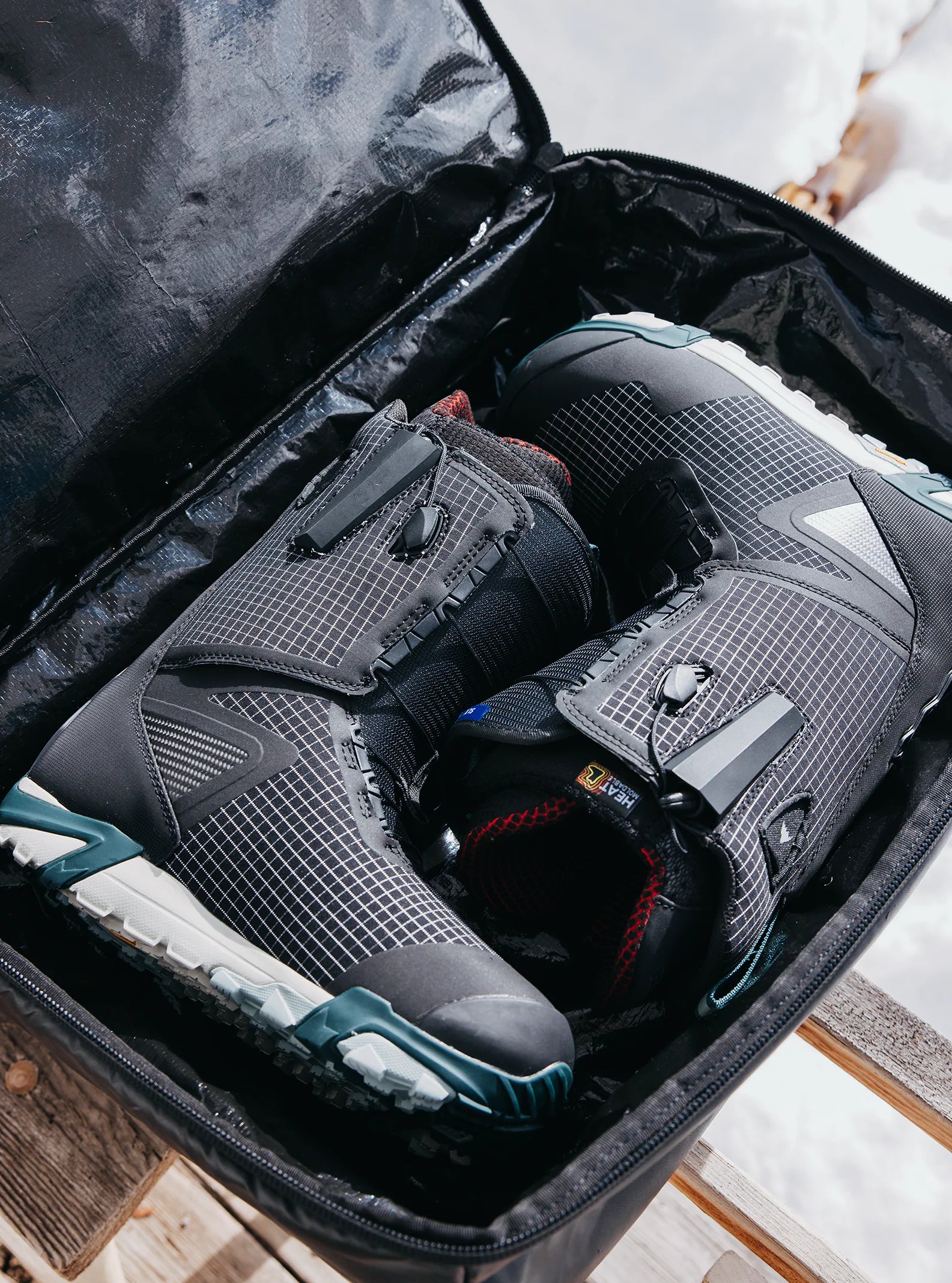 Burton Gig 70L Duffel Bag - A black duffel bag with a white logo on the side and a handle at the top.