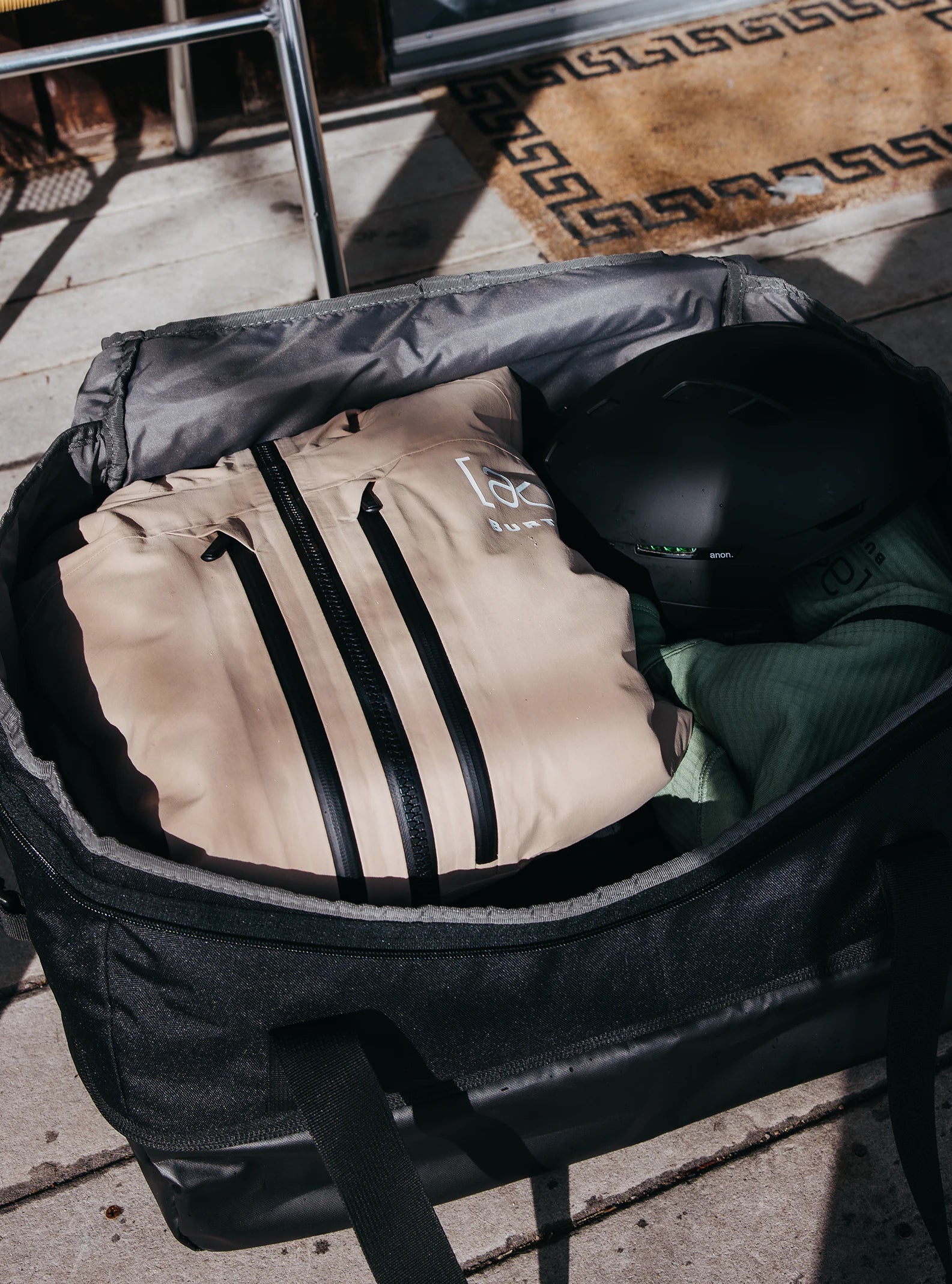 Burton Gig 70L Duffel Bag - A large, tan duffel bag with black zippers and accents.