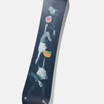 Burton Good Company Snowboard 2025 - A black snowboard with a white logo and text on top, featuring a man riding it in mid-air.