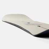 Burton Good Company Snowboard 2025 - A white snowboard with a blue and red logo on top, featuring a pink rectangle outline around it.