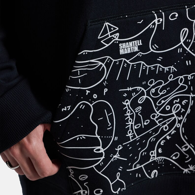 Anon Shantell Martin Pullover Hoodie - A black hoodie with a white line drawing of mountains and faces, featuring the words "Shantell Martin" in white at the top.