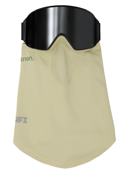 A beige face mask integrated with a black ski goggle. The mask covers the lower face and neck, with a small mesh area over the mouth. The brand name "anon." is printed in green on the left side of the mask, and "MFI" is printed in white on the lower left.