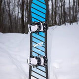 Burton Junior's Smalls Snowboard 2025 - A blue snowboard with black stripes and a black border, featuring the word "BURTON" in white letters on its side.