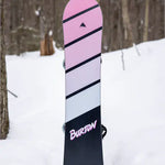 Burton Junior's Smalls Snowboard 2025 - A pink snowboard with black stripes and a small logo at the top.
