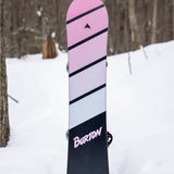 Burton Junior's Smalls Snowboard 2025 - A pink snowboard with black stripes and a small logo at the top.