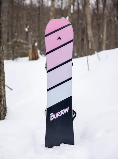 Burton Junior's Smalls Snowboard 2025 - A pink snowboard with black stripes and a small logo at the top.