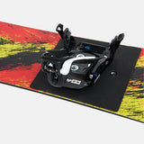 Burton Junior's Grom Step On Snowboard Bindings - A black and white binding with a circular logo on the front, featuring a small mountain peak design.