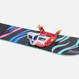 Burton Junior's Grom Step On Snowboard Bindings - A black snowboard with blue and pink stripes, featuring a red, white, and blue binding in the center.