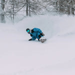 Rome Ravine Pro Snowboard 2025 - A snowboard with a white base and blue patterned design, featuring the word "ROME" in black letters on the bottom of the board.