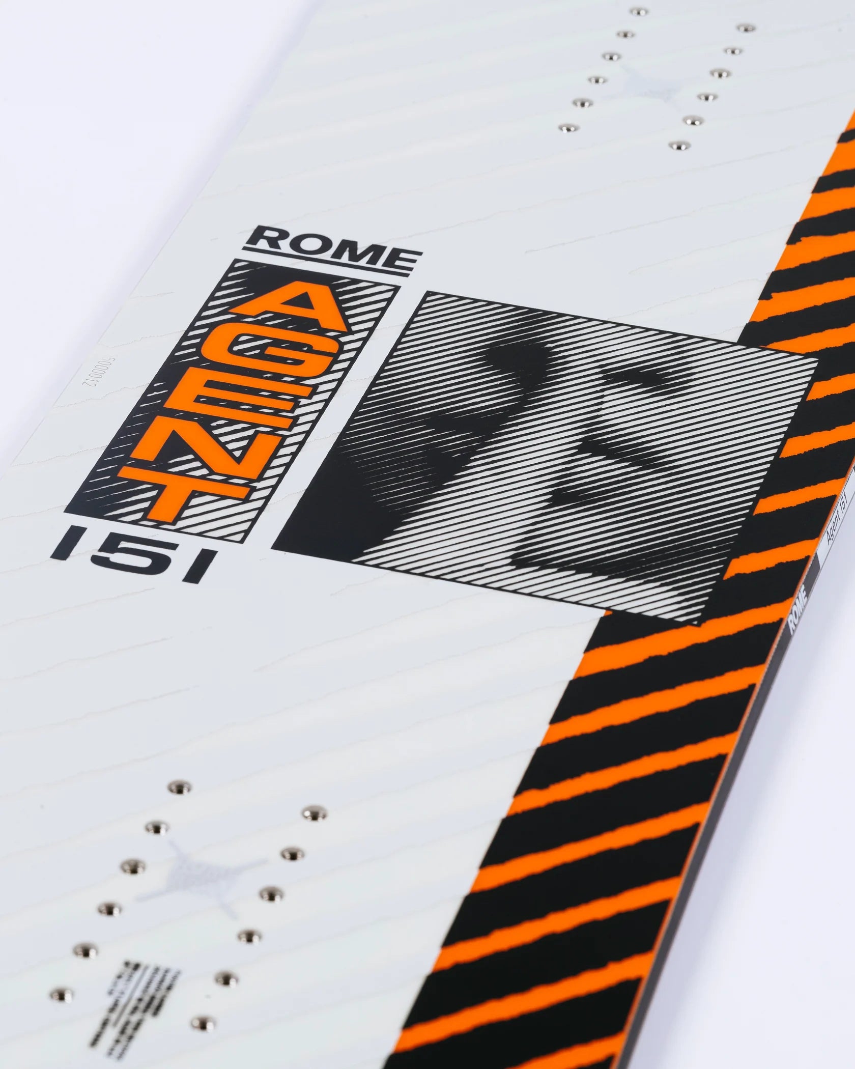 Rome Agent Snowboard 2025 - A white snowboard with black and orange stripes on its side, featuring a black-and-white photo of a man's face in a square frame.