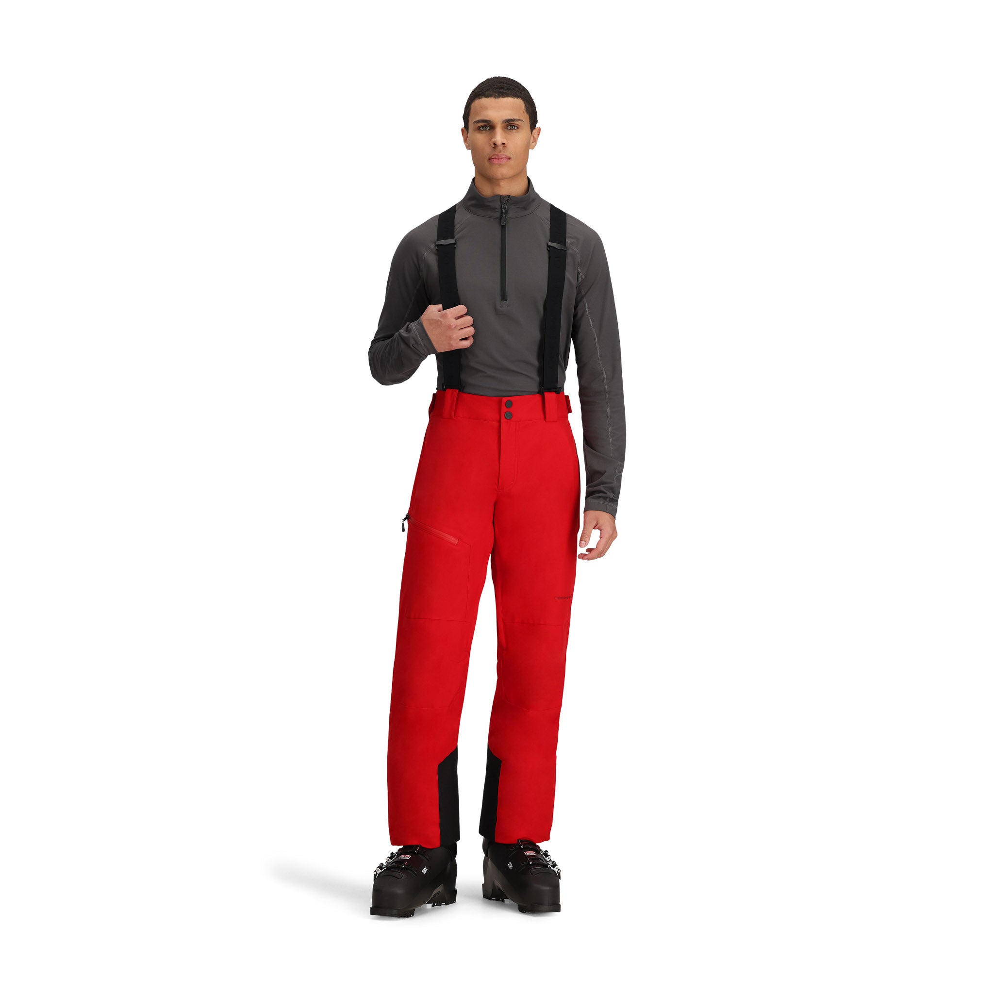 Obermeyer Force Insulated Suspender Pant 2025 - A pair of red snow pants with black suspenders and a zippered pocket on the side.