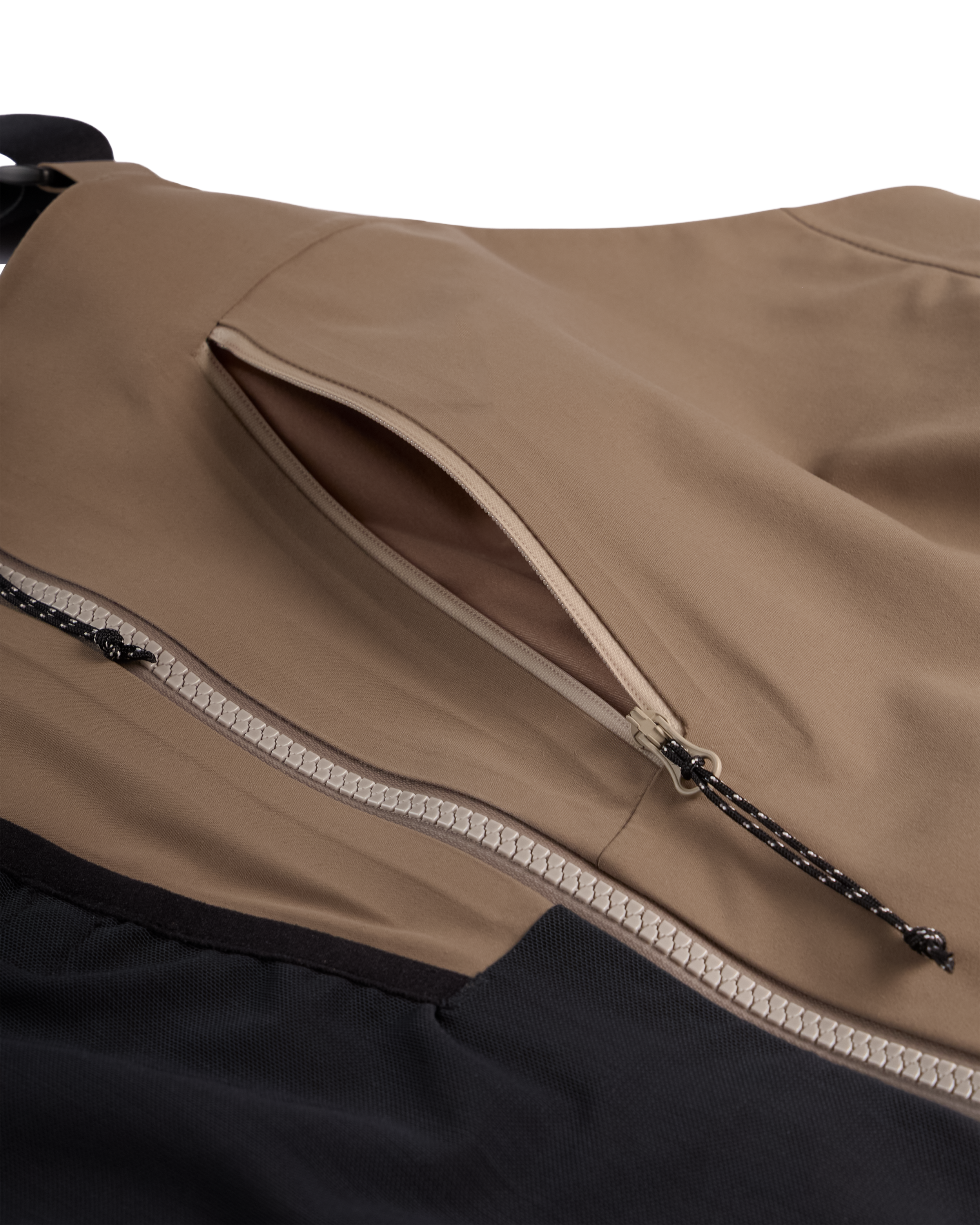 Men's mushroom shell bib pants close-up of chest zipper and pocket trim panel