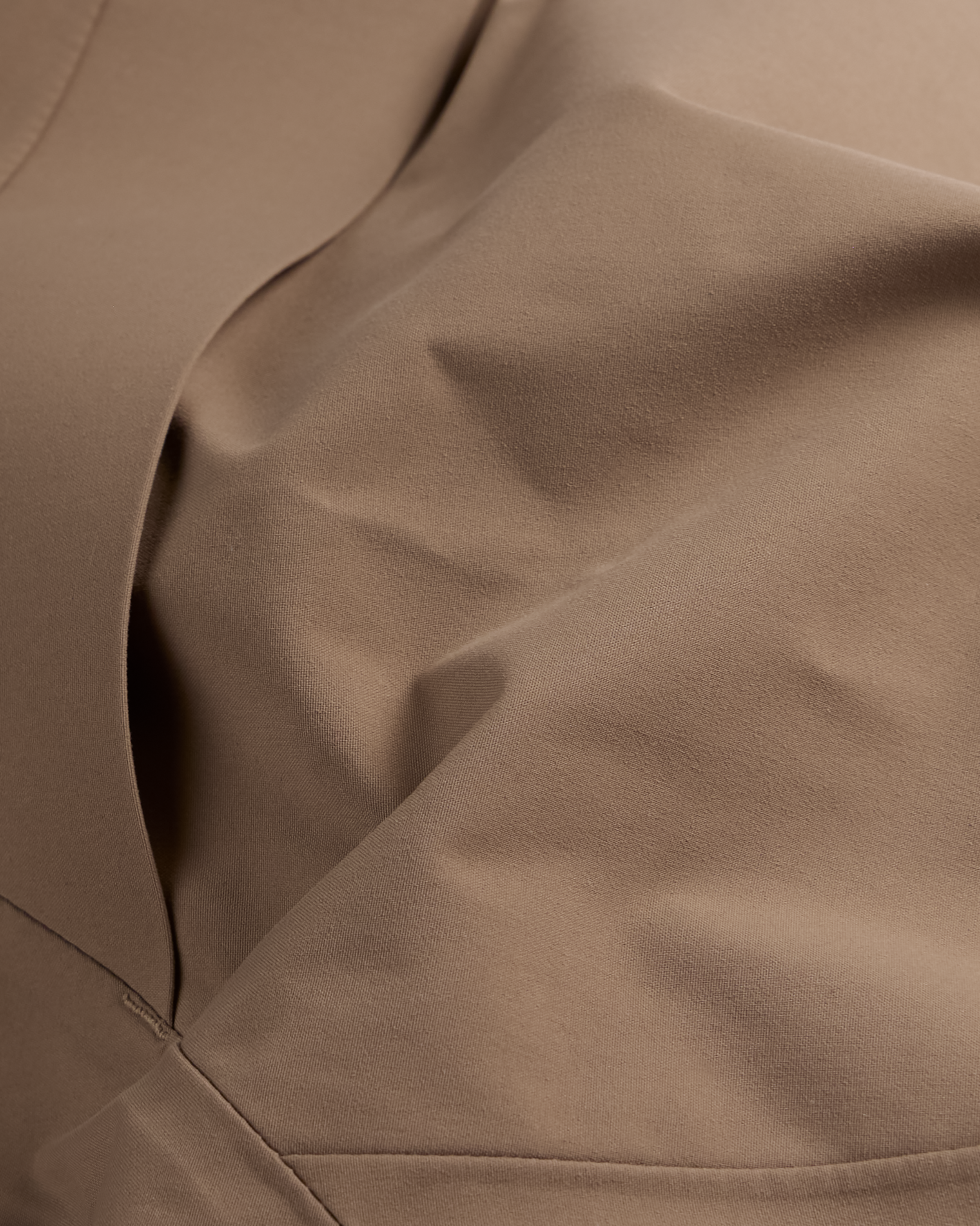 Men's mushroom shell bib pants close-up of curved stitched panel details