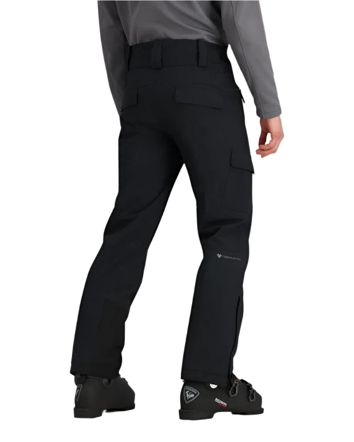 Obermeyer Alpinist Stretch Pant 2025 - Black pants with a subtle white logo on the left thigh and two zippered pockets on the back.