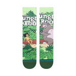 JUNGLE BOOK BY TRAVIS C SK 2023 - A pair of socks featuring a jungle scene with Mowgli and Baloo from The Jungle Book, in muted colors.