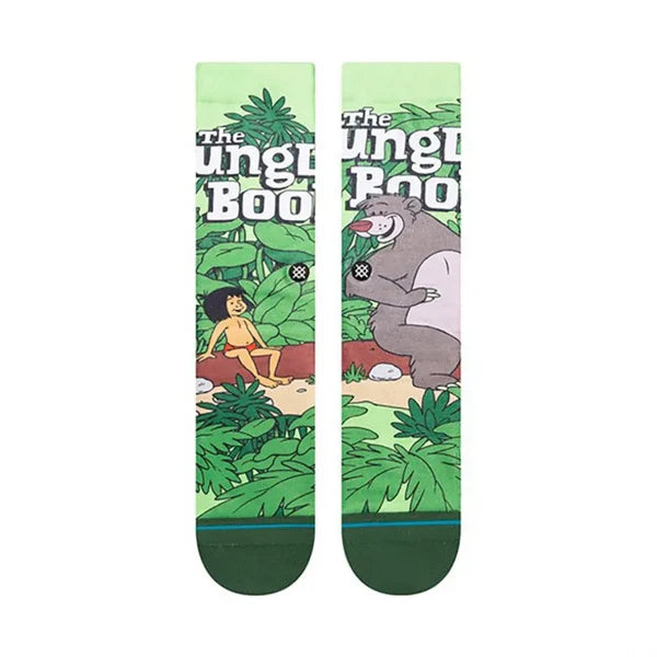 JUNGLE BOOK BY TRAVIS C SK 2023 - A pair of socks featuring a jungle scene with Mowgli and Baloo from The Jungle Book, in muted colors.