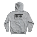 Union Team Hoodie 2026 - A light gray hoodie with a black logo on the chest that reads "UNION" in bold letters, outlined by a thin white border.