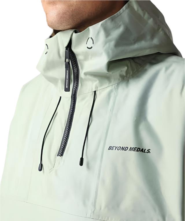 Beyond Medals Anorak 2L Shell Jacket 2024 - A light green jacket with a hood and black zipper.