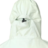 Beyond Medals Anorak 2L Shell Jacket 2024 - A white jacket with a hood, featuring a black zipper and adjustable cuffs.