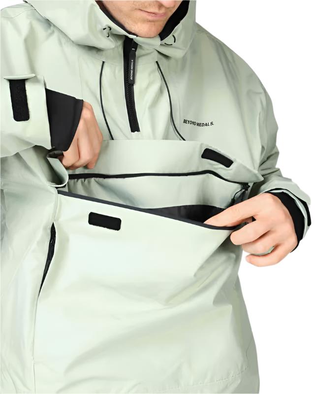 Beyond Medals Anorak 2L Shell Jacket 2024 - A light green jacket with black accents and a hood, featuring two zippered pockets on the front.