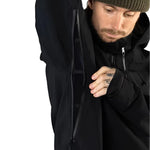 Beyond Medals Tech Shell Jacket 3L 2025 - A black jacket with a zippered chest pocket and adjustable cuffs.