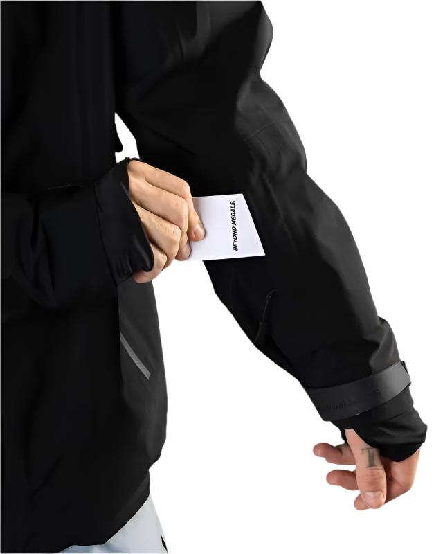 Beyond Medals - A black jacket with a white logo on the left chest and a zippered pocket on the right side.