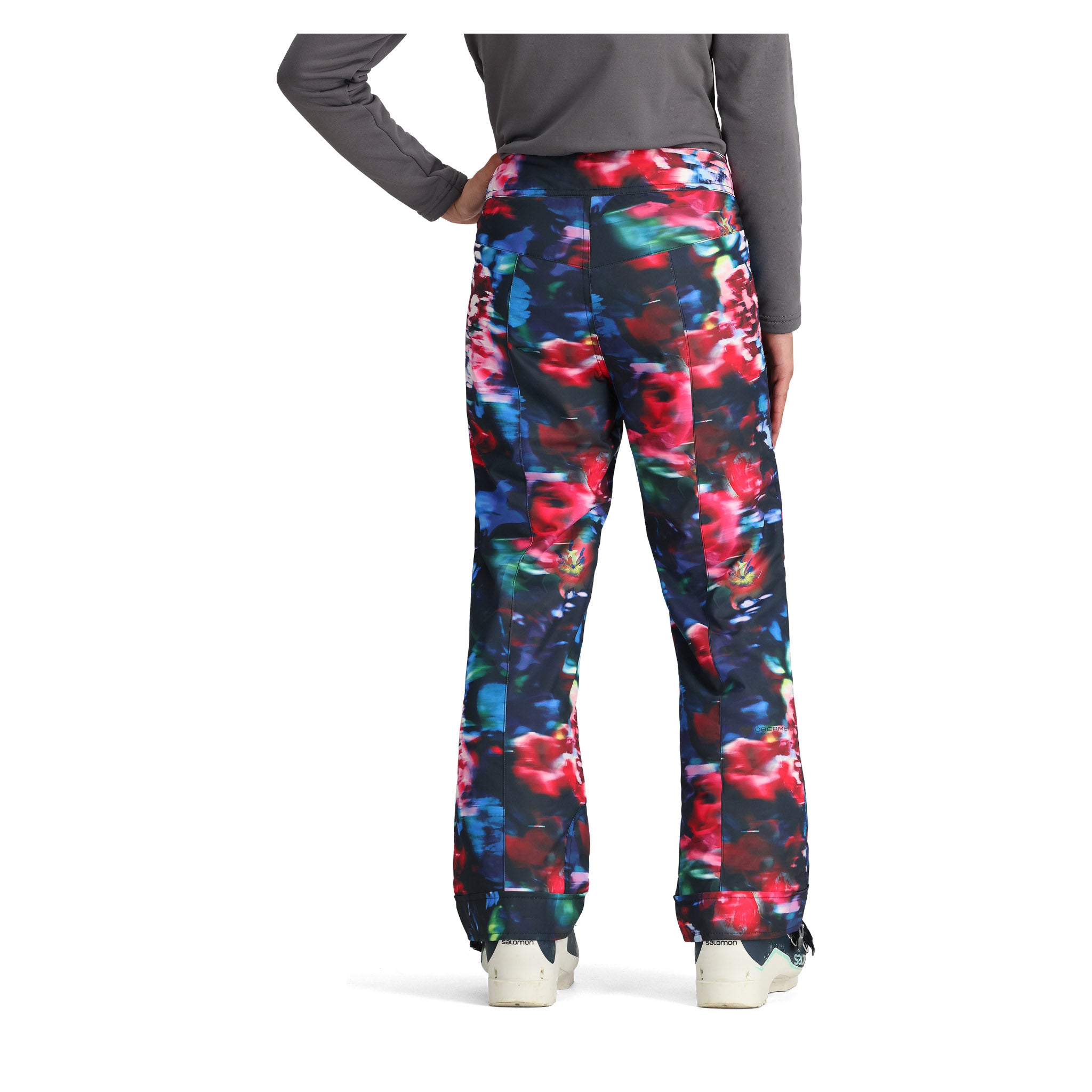 Obermeyer Girl's Brooke Print Pant 2025 - A pair of girls' snow pants with a multicolored abstract floral print on a black background.