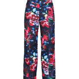 Obermeyer Girl's Brooke Print Pant 2025 - A pair of navy blue snow pants with a colorful floral pattern featuring red, pink, and green flowers.