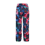 Obermeyer Girl's Brooke Print Pant 2025 - A pair of navy blue snow pants with a colorful floral print featuring pink, green, and white flowers.
