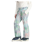 Obermeyer Girl's Brooke Print Pant 2025 - A pair of pastel-colored snow pants with a geometric print in shades of pink, green, and gray.