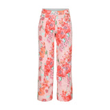 Obermeyer Girl's Brooke Print Pant 2025 - A pair of pink pants with a floral pattern featuring red and orange flowers.
