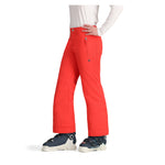 Obermeyer Girl's Brooke Insulated Pant 2025 - A pair of bright coral-colored snow pants with a small black logo on the left thigh and silver zippers.