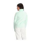 Obermeyer Girl's Furry Fleece Top 2025 - A mint green fleece top with a furry texture and a high collar, worn by a girl facing away from the camera.