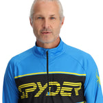 Spyder Men's Paramount 1/2 Zip Top 2025 - A blue and black zip-up top with a yellow logo on the chest.