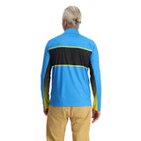 Spyder Men's Paramount 1/2 Zip Top - A blue and black zip-up top with a collar, worn by an older man with gray hair pulled back into a bun.